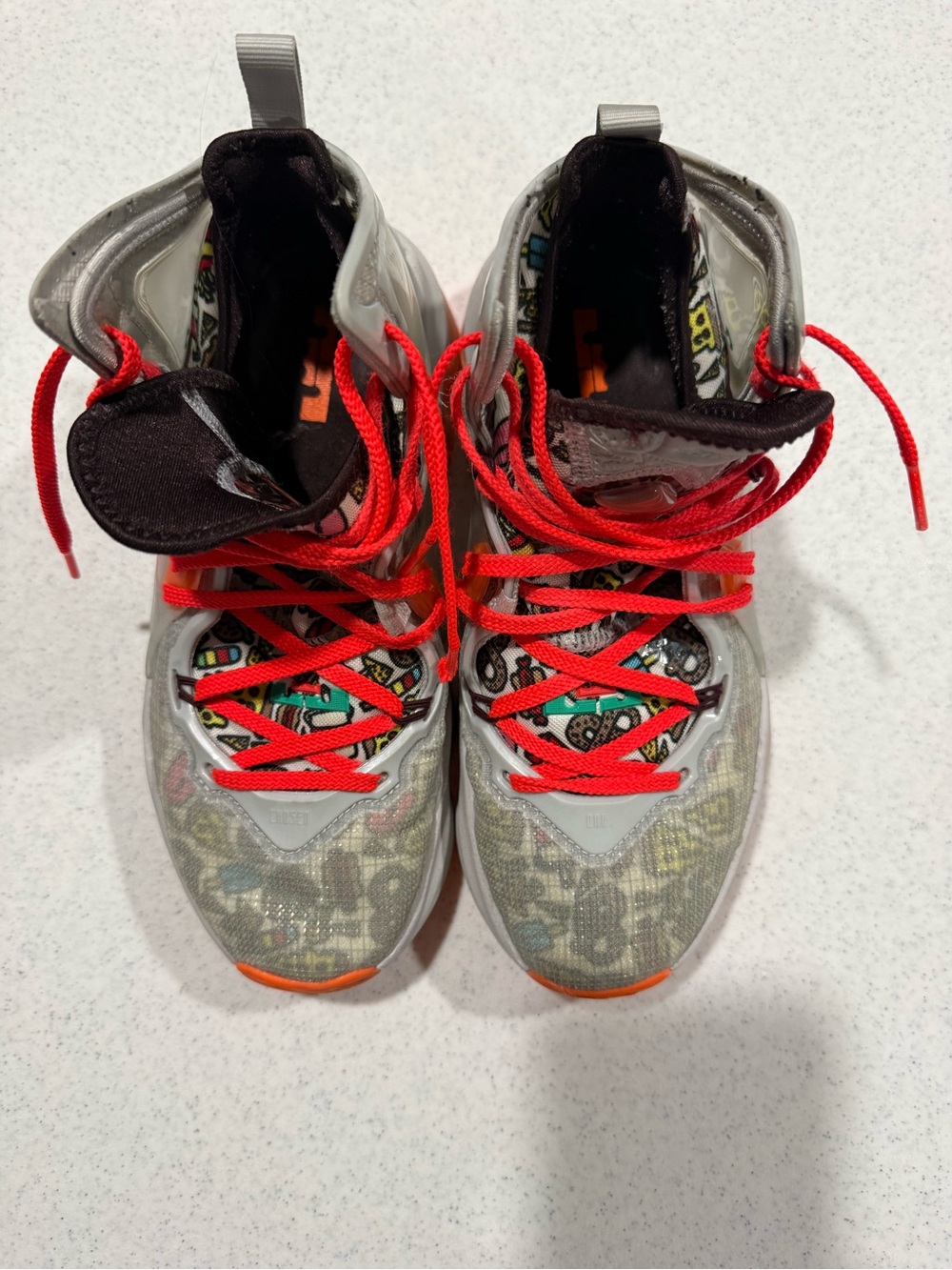 Kids Silver Sneakers with Bright Red Laces and Graphic Accents